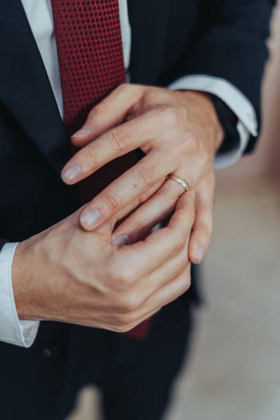 istock Young Groom is Putting his Wedding Ring on his Finger 1460871117