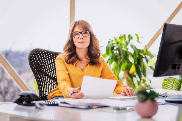 Middle aged businesswoman working from home stock photo