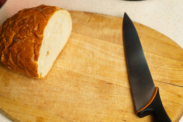 istock Bread on wooden cutting board with a knife 1460871651