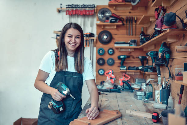 Cute Female Carpenter Feeling Confident At Her Job Post Cute Female Carpenter Feeling Confident At Her Job Post holding drill stock pictures, royalty-free photos & images