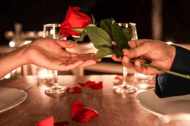 istock Man giving woman a rose for Valentine's Day gift. 1460872842