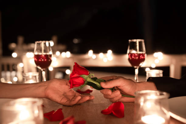 istock Man giving woman a rose 1460872897