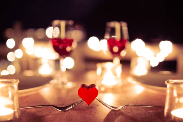 heart and romantic candlelight dinner setting - restaurant wine table table for two imagens e fotografias de stock