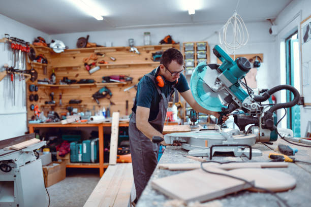 istock Carpenter Carefully Using Massive Circular Saw To Cut Desired Plank Shape 1460873256