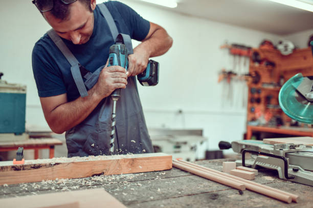 istock Front View Of Expert Carpenter Drilling Holes In Plank 1460873667
