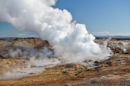 Hot steam rising to the sky in Gunnuhver geothermal area in Southern Peninsula in Iceland