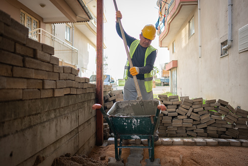 construction worker preparing cement for building wall