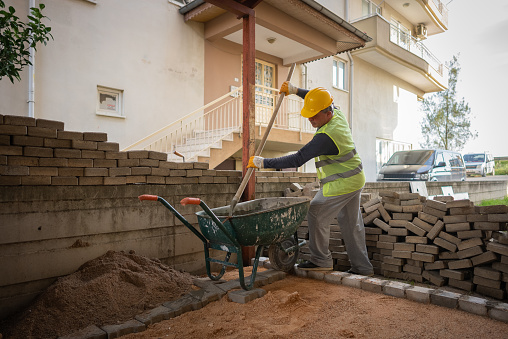 construction worker preparing cement for building wall