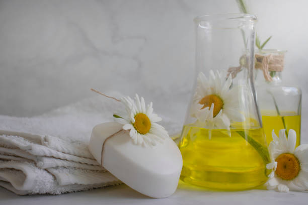 istock Cosmetic soap, chamomile flower on a light background 1460879736