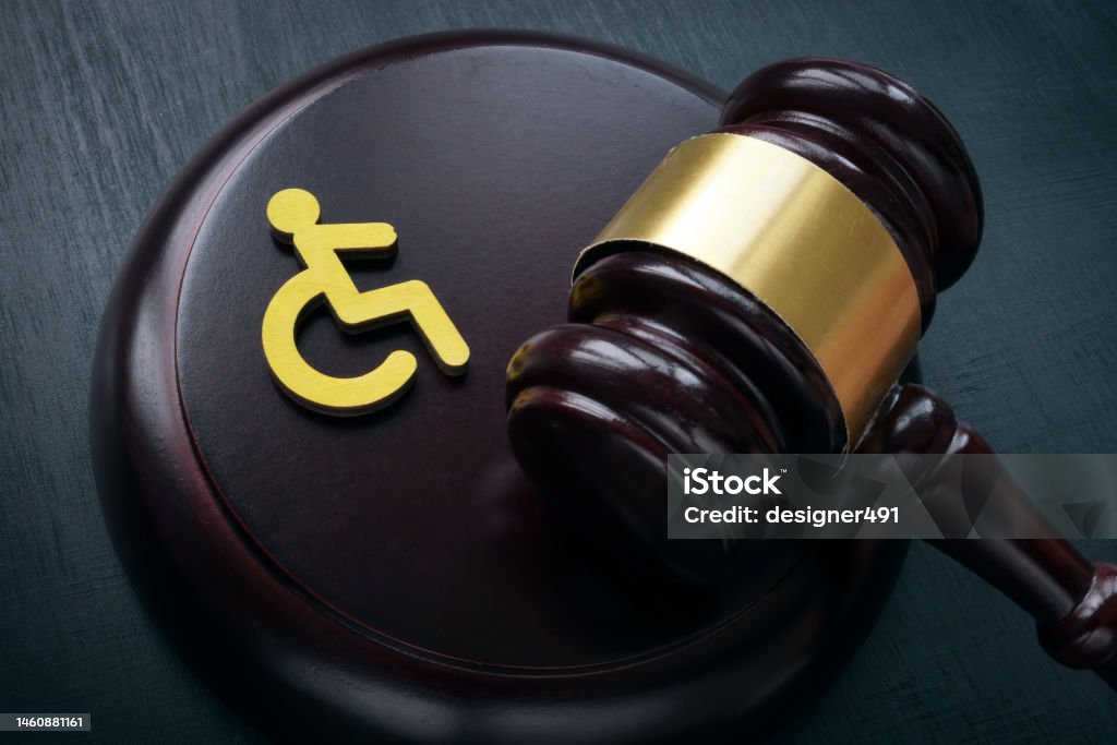 Disabled person sign and gavel. Accessibility law concept. Disability Stock Photo