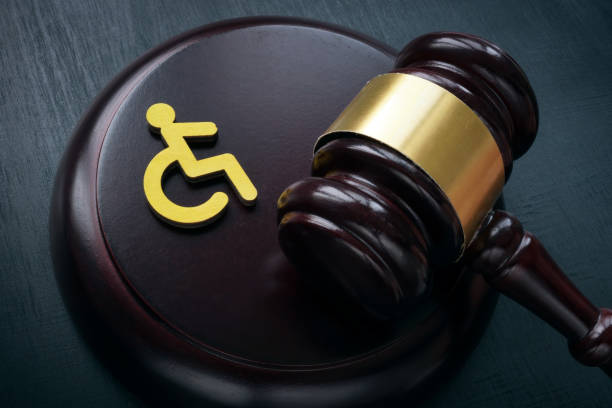 Disabled person sign and gavel. Accessibility law concept. stock photo
