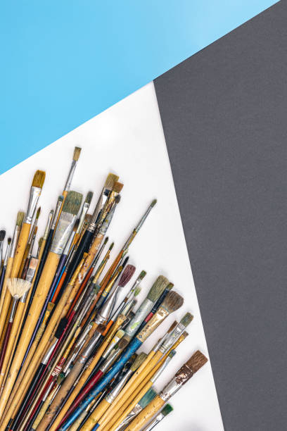 istock Many brushes for painting on a colored background, top view. 1460884555