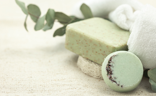 Spa composition with colorful handmade soap on a blurred background, copy space.
