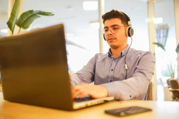 istock young man working remotely hybrid with laptop in cafe 1460886012