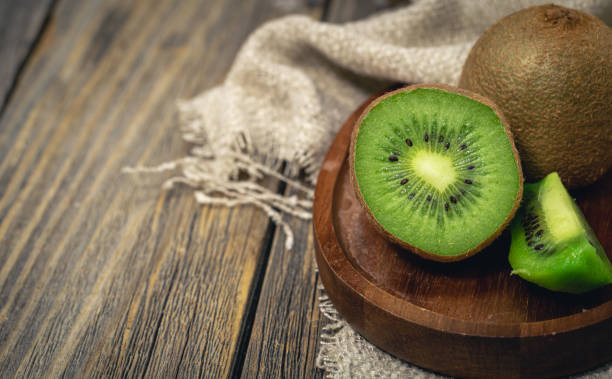 istock Close -up, cut fruit kiwi on a wooden background, rustic style. 1460886559