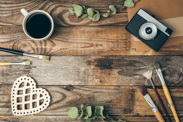 Vintage background with retro camera and paintbrushes, flat lay.
