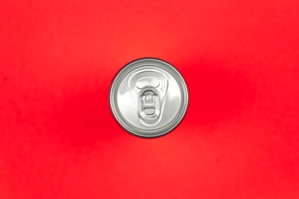 istock Aluminum drink or beverage can with pull ring on a red background, flat lay. 1460888026