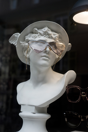 Closeup of eyeglasses presentaion on statue  in optician  store showroom