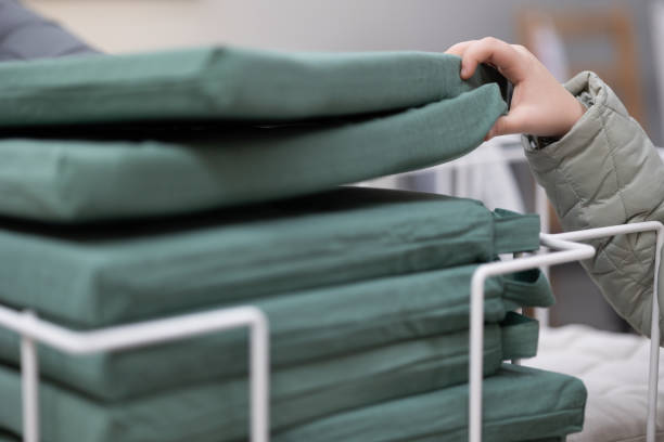 istock Hand Chooses a Pillow For a Chair 1460894495