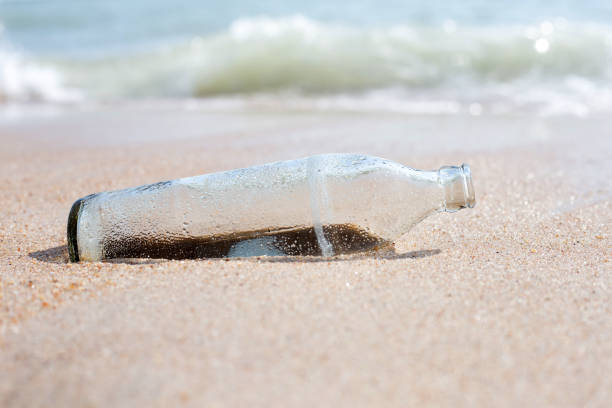 istock Glass bottle on the beach 1460898039