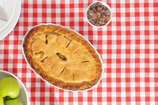 apple pie on a red checkered tablecloth