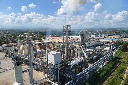 Aerial view of oil and gas refining petrochemical factory with high refinery plant manufacture structure. Global production and manufacturing concept.