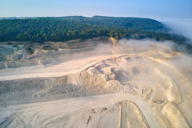 istock Aerial view of open pit mining site of limestone materials extraction for construction industry with excavators and dump trucks. 1460904784