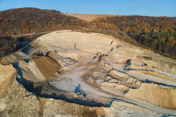 istock Aerial view of open pit mining site of limestone materials for construction industry with excavators and dump trucks 1460905347