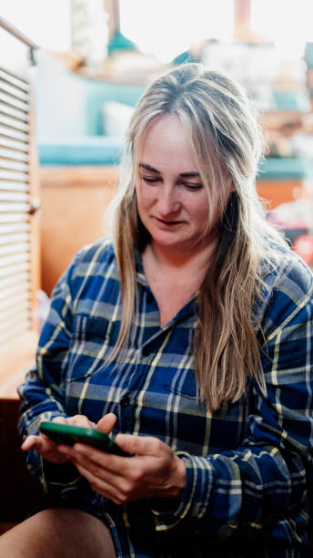 istock Woman making a difficult decision looks at her phone with concentration 1460906109