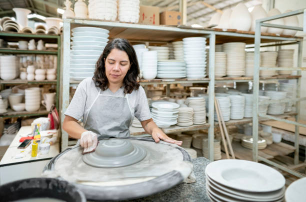 istock Mature woman making ceramic plate on potter's wheel 1460906276
