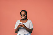 A Happy Beautiful Businesswoman With Glasses Texting On Her Mobile Phone