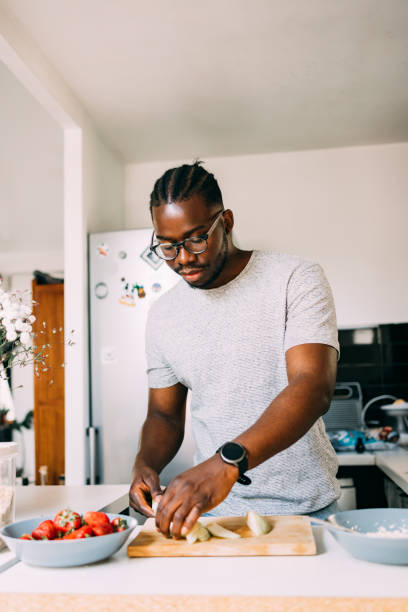 istock A Serious Man With Glasses Preparing Healthy Breakfast While Standing In The Kitchen 1460914786