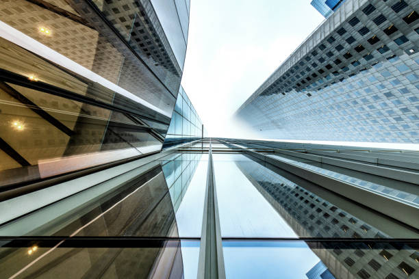 City Skyscraper Abstract Modern skyscrapers shot from directly below using a wide angle lens in downtown Houston, Texas on an overcast winter morning creating diverging lines and reflections in this abstract image. generic description stock pictures, royalty-free photos & images