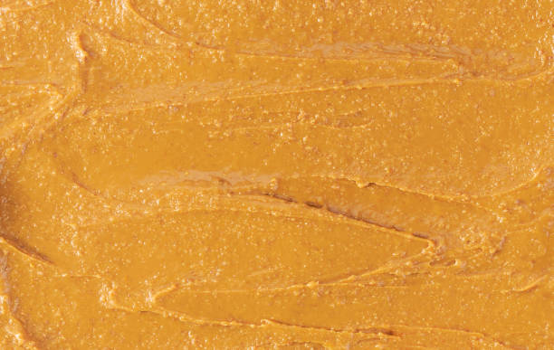 istock peanut butter background, top view. creamy peanut butter textured. 1460916837