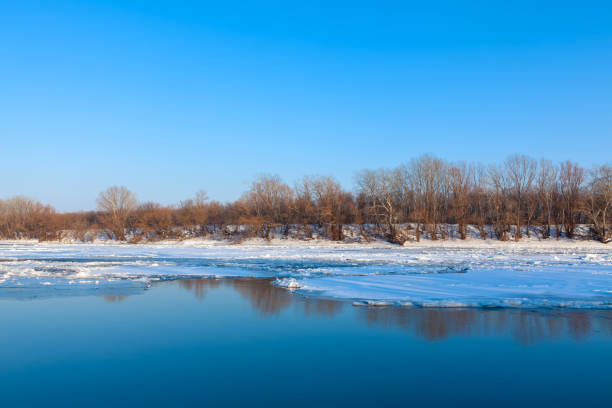 Ice melting on surface of frozen river . Springtime with ice on the water