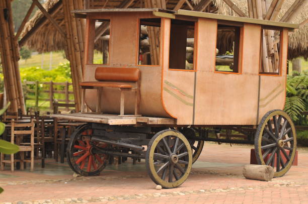 Vintage wooden carriage in the garden of a country house Vintage wooden carriage in the garden of a country house, Stagecoach chuck wagon stock pictures, royalty-free photos & images