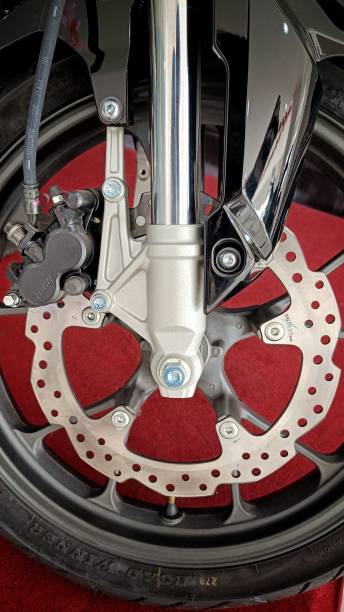 istock Close Up Motorcycle braking disc with silver color on black casting wheels 1460924331