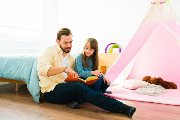 istock Adorable family reading a book together 1460932743