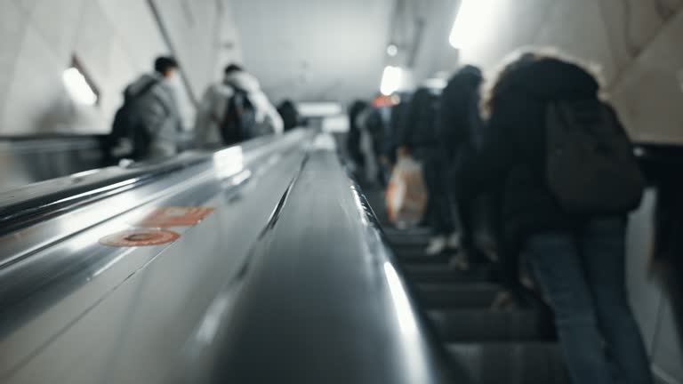 SLO MO Defocused shot of people on escalator