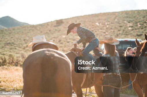 istock Brave Kid Mounting a Horse 1460945242