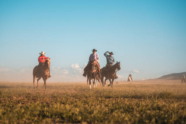 istock Small Active Group of Cowboys Horseback Riding Together 1460945323