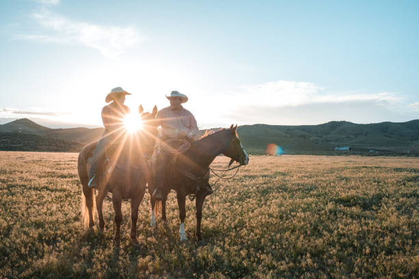 istock Sunshine Passing between a Couple that is Riding Horses 1460945406