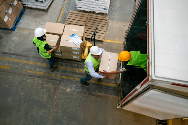 Group of warehouse workers loading a truck with boxes
