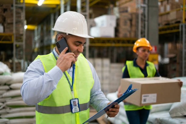 istock Happy warehouse worker talking on the phone 1460954612