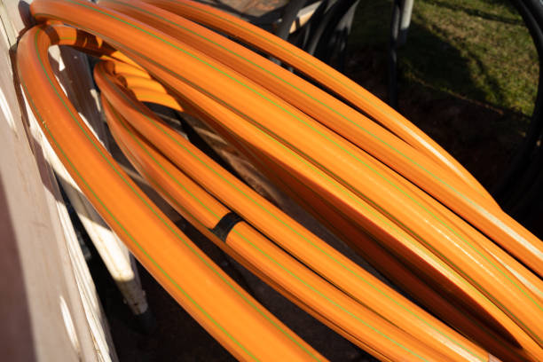 istock Orange colored cable for fiber glass internet expansion in a construction site 1460955368