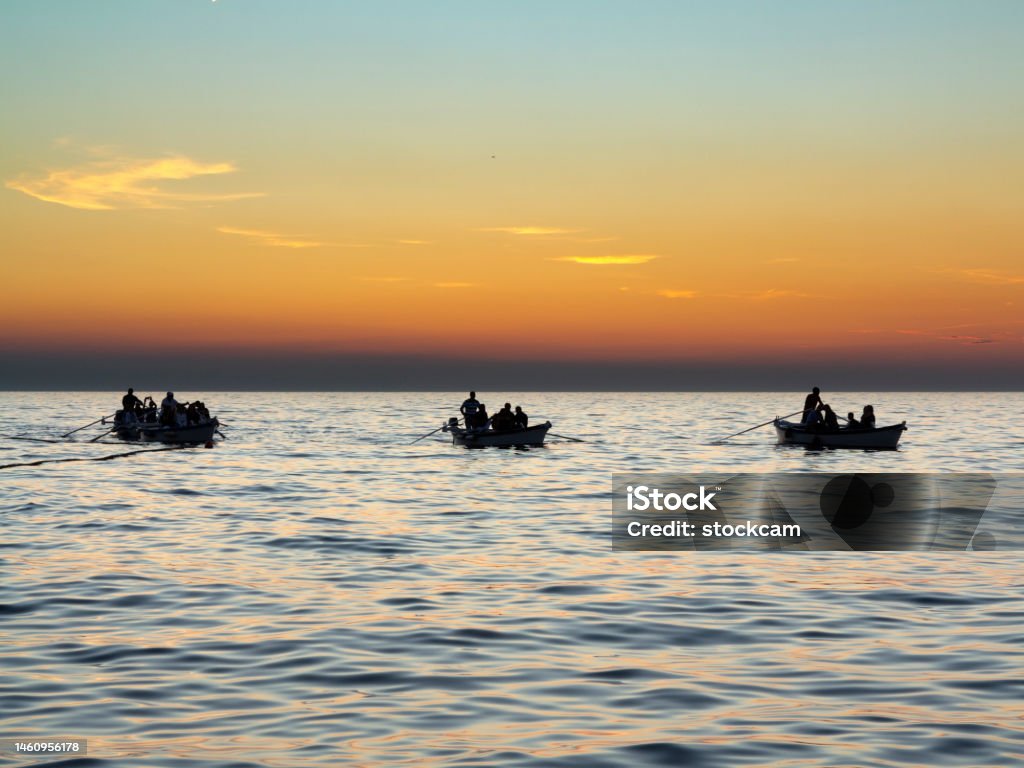 Boats in the evening at Rovinj, Croatia The silhouette of boats in the bay of Rovinj, Croatia at dusk Coastline Stock Photo
