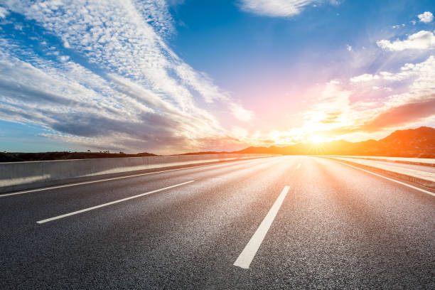 istock Asphalt road with sky clouds at sunrise 1460956394