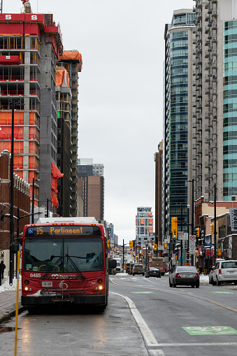 Ottawa, Canada - January 23, 2023: Public bus in downtown of Ottawa, Rideau street with bike lane