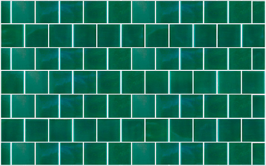 Green ceramic tile background. Old vintage ceramic tiles in green to decorate the kitchen or bathroom. High quality photo