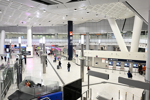 Birmingham, UK - Passengers inside the spacious interior of Birmingham's New Street train station, with several retail and restaurant options available.